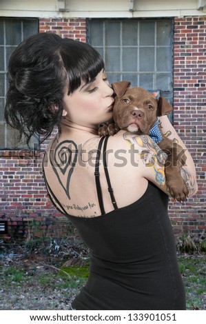 Beautiful young woman with her pit bull puppy