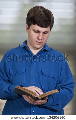 Young handsome man busy reading a book