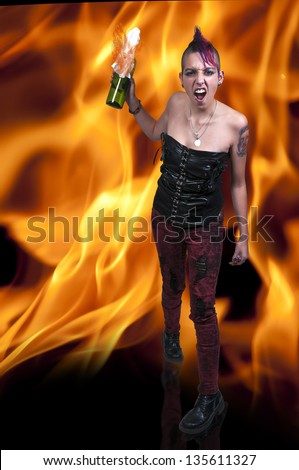 Beautiful rebellious punk rock woman throwing a molotov cocktail