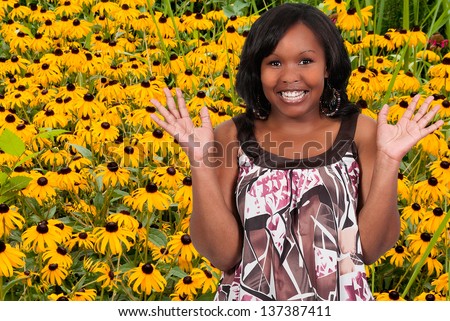 Black woman with the common wild flower known as a Blackeyed Susan.