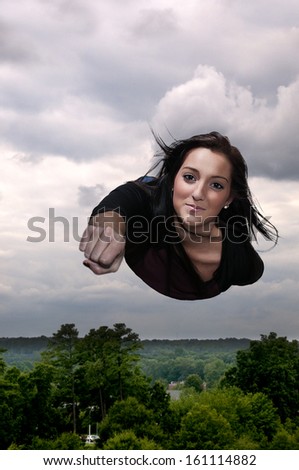Beautiful young woman flying through the sky