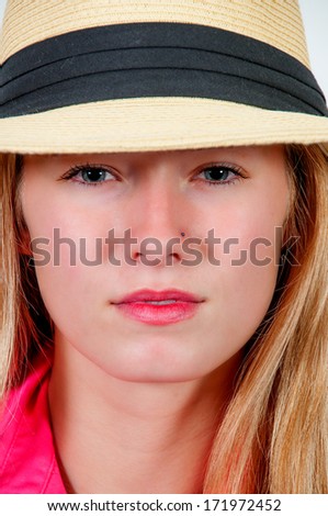 Beautiful young woman in a fedora hat