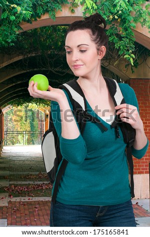 Beautiful woman college student with an apple