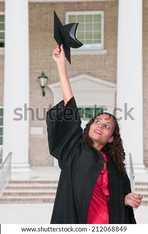 Young woman in her graduation robes throwing her cap (photo illustration / image composite)