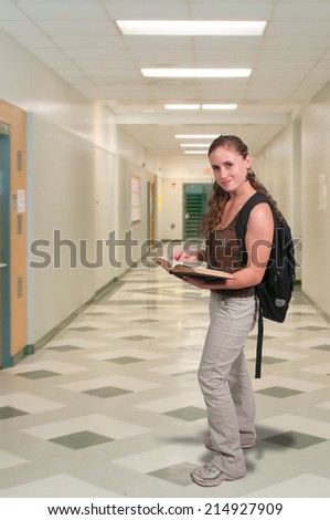 Young college or high school woman with a book bag reading