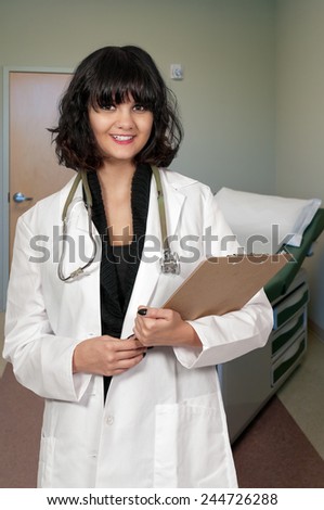 Beautiful young woman doctor in a lab coat holding a patient record