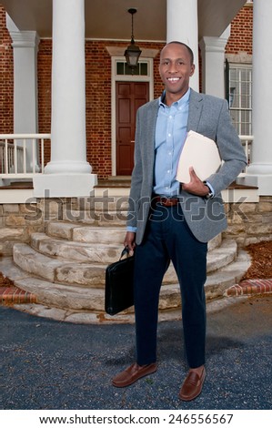 Handsome black African American business man with manila folders full of documents