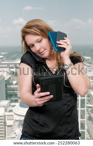 Beautiful woman talking texting and multitasking while juggling multiple cell phones and conversations