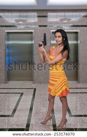 Beautiful police detective woman on the job with a gun