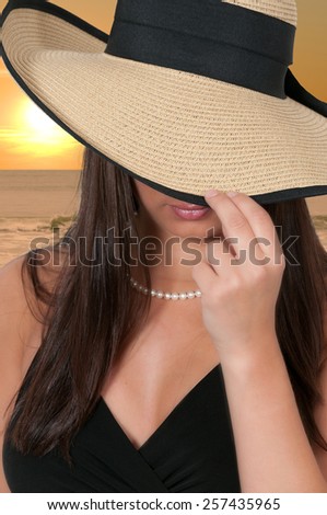 Beautiful young sexy woman wearing a floppy hat
