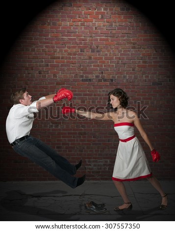 Young couple having a fight with boxing gloves