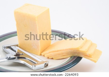 Slices of Cheddar Cheese and a Cheese Slicer