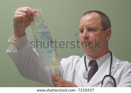 A medical doctor preparing an IV solution.