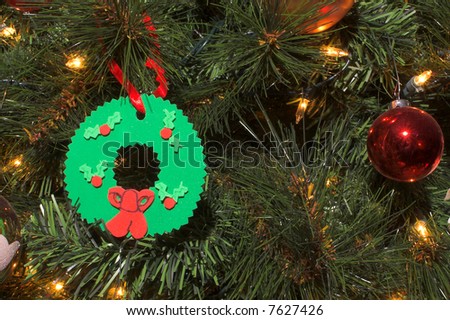 Christmas ornaments on a decorated holiday tree.