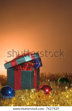 A set of Christmas gifts inside a large wrapped box.