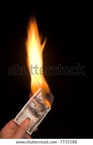 A one hundred dollar bill on fire.