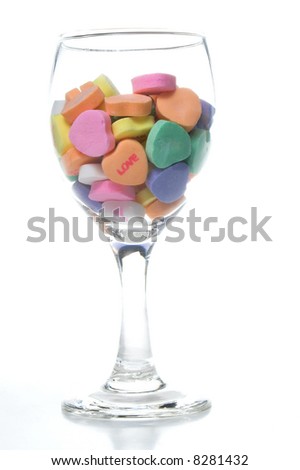 Conversation hearts in a wine glass. Concept of love.