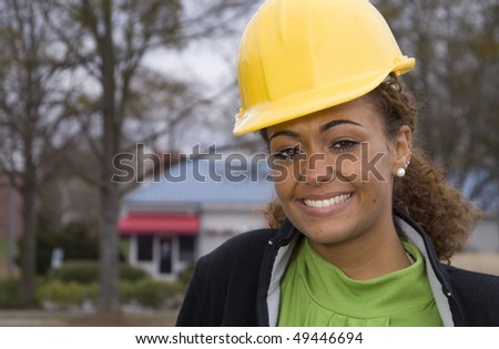 A beautiful young female construction supervisor on a job site