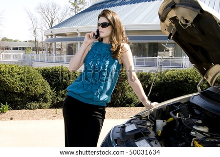 A woman with car trouble calling for help