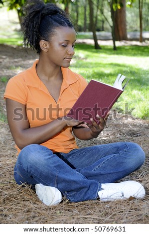 A young African American woman reading a book