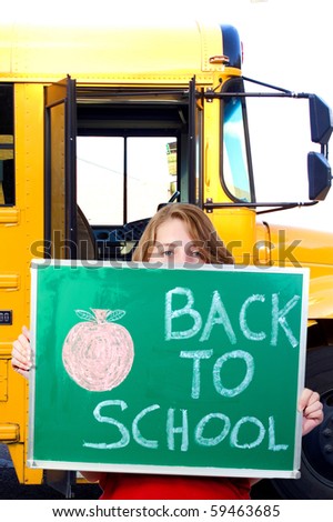 A beautiful teenage girl holding a back to school sign