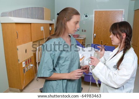 A beautiful young female doctor holding an IV bag