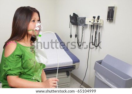 A beautiful young woman wearing an oxygen mask