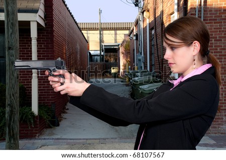 A beautiful police detective woman on the job with a gun