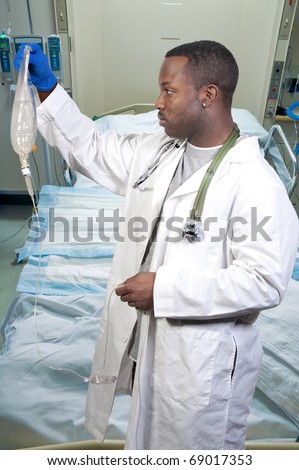 A black man African American doctor holding an IV bag