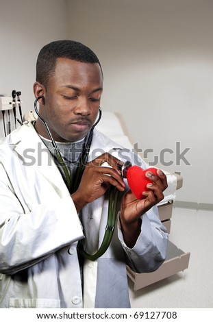 A black male African American doctor cardiologist holding a red heart