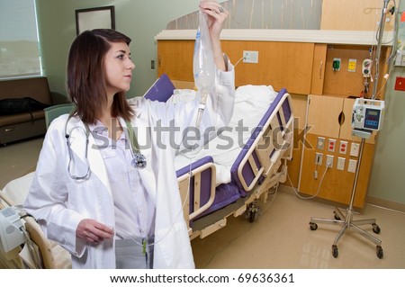 A beautiful young woman doctor holding an IV bag
