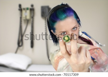 A syringe being held by a blurred doctor