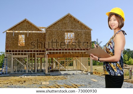 A beautiful Asian Female Construction Worker on a job site.