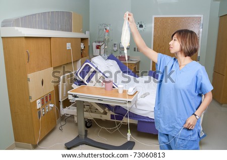 A beautiful young Asian female doctor holding an IV bag