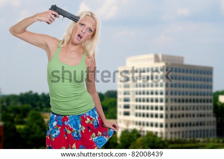 A beautiful woman holding a gun to her head threatening suicide
