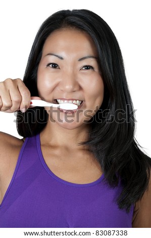 A beautiful Asian woman practicing good oral dental care by brushing her teeth