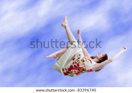 A beautiful young woman falling through the sky