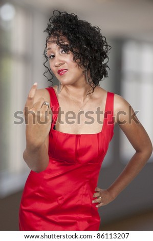 A beautiful woman signaling with her finger for someone to come here
