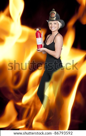 A beautiful woman firefighter with a fire extinguisher