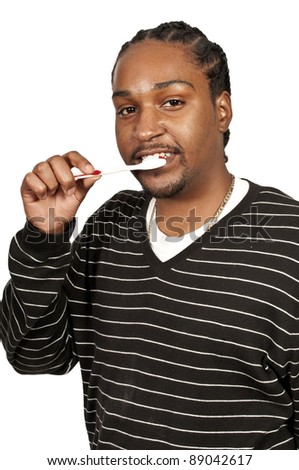 Black African American man practicing good oral dental care by brushing his teeth