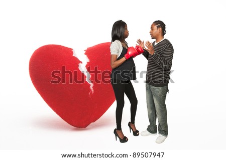 stock photo Beautiful young black pregnant woman wearing a boxing glove 