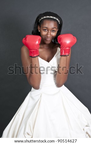 Black African American Woman Bride in a wedding dress with boxing gloves