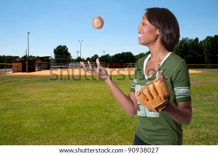Black African American woman playing baseball at a community park