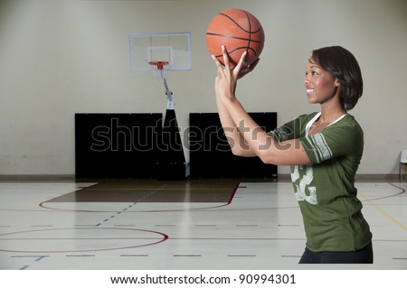Beautiful black African American woman playing a game of basketball
