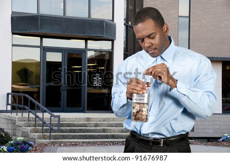 A young man holding a jar of money coins labeled retirement account