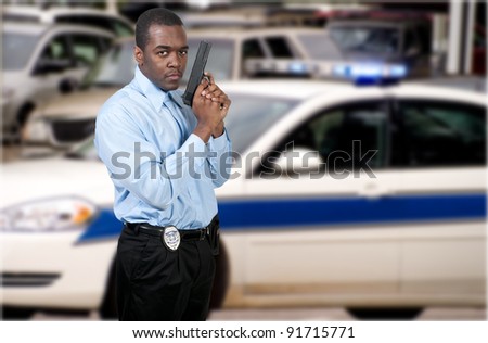 A black African American police detective man on the job with a gun