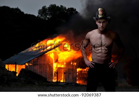 Young attractive male firefighter at a fire