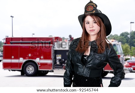 A beautiful woman firefighter at a fire
