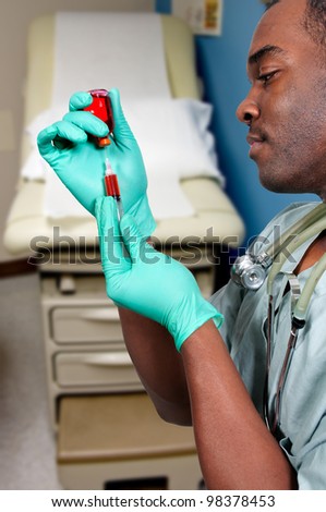 Black African American medical doctor preparing an injection in a syringe.
