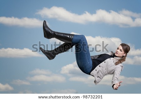 A beautiful young woman falling through the sky